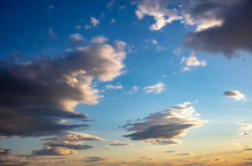 Sunrise, sunset few clouds on blue sky background. Copy space.