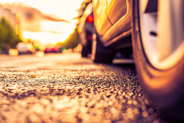 Sun after the rain in the city, headlights of approaching cars, the view from the road level from the wheel of the car