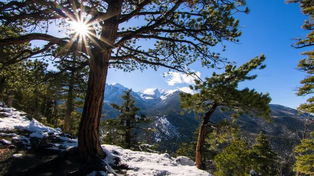 Time Lapse Shot Of Trees Growing Over Snowy Mountain Against Sky On Sunny Day - Hayden Pass, Colorado