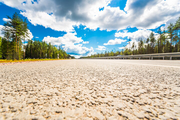 Rural road passing through the forest. View from the road level