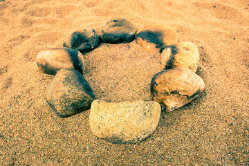 Fototapeta na wymiar Circle of stones for the bonfire on the beach