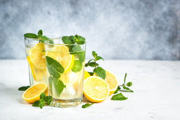 Lemonad drink in the glass. Traditional summer drink with lemon, mint and ice cube.