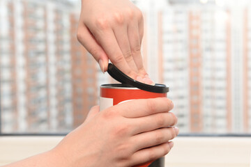 Female hands opening the lid of a food jar