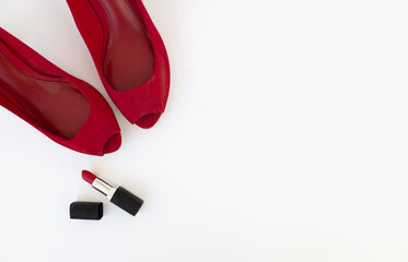 Red shoes and red lipstick on a white background. Beauty blog concept. Flat lay. top view