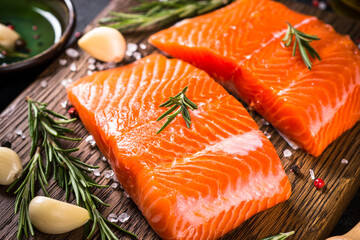 Strawberry jam in the glass jar with fresh berries at wooden table.