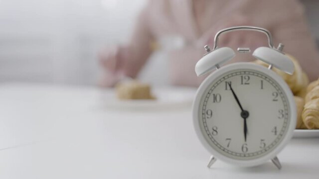 Woman quickly eating cake before six o'clock, weight loss dieting restrictions