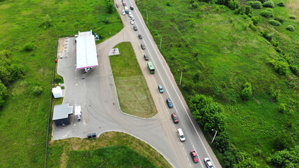 Aerial. Car traffic on the highway near the petrol station. View above from drone.