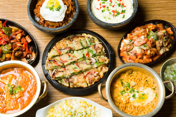 A menu selection of traditional Korean dishes at an Asian restaurant.  ........