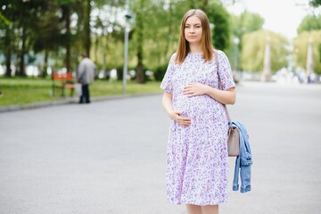 Pregnant woman resting in the park