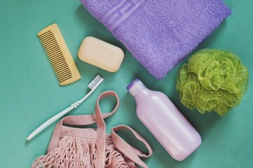 Flat lay composition photo bath products, toiletries set. Shampoo bottle, toothbrush, wooden comb,...
