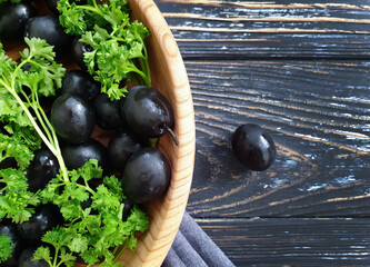 black olives on a wooden background