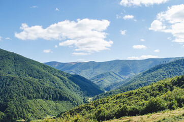 Carpathian landscape with forest slopes, mountain ranges and peaks. Holidays in the mountains