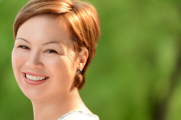 Smiling  young woman with short hair cinematic headshot