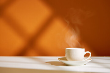 Close-up of coffee cup on table at direct sunlight