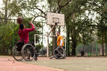 wheelchair man throwing basketball in open court..