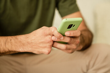 disabled person typing on screen of cell phone.