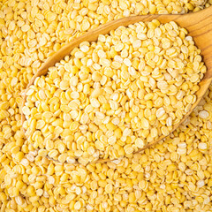 split green mung beans in wooden spoon closeup