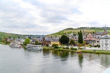 Fototapeta na wymiar Panorama view on Traben-Trarbach am Mosel. Beautiful historical town on the loop of romantic Moselle river. Ship, church, hill. Rhineland-Palatinate, Germany
