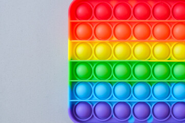 Rainbow pop it toy fidget on a background