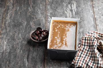 Sticky toffee pudding butter sponge with dates on wooden table