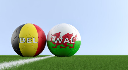 Wales vs. Belgium Soccer Match - Leather balls in Wales and Belgium national colors on a soccer field. Copy space on the right side - 3D Rendering 