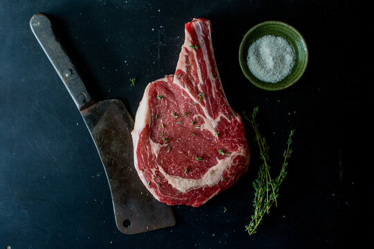 Raw steak with meat cleaver 