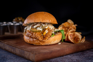 Appetizing crispy chicken burger with fries