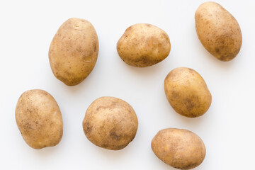 young potatoes on a white plate, potatoes on a white plate  - obrazy, fototapety, plakaty