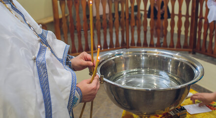 The baptism of a child in the church, the interior of the church.