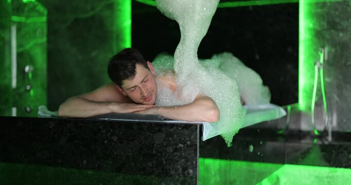 Man on the procedure of the foam massage in the hammam. Wellness and spa concept