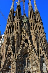 Fototapeta premium The towers of the famous Sagrada Familia cathedral in Barcelona in Spain with construction work in the background
