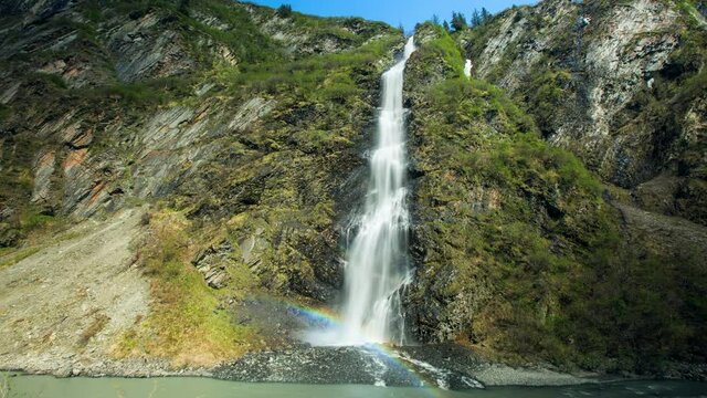 Time Lapse Lockdown Shot Of Idyllic View Of Waterfall Amidst Rock Against Clear On Sunny Day - Valdez, Alaska