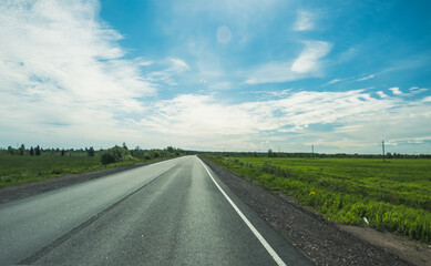 The road among the Karelian taiga. Pine forest on the side of the road. Trip to Karelia. Highway among the trees. Driving on a trip to beautiful places. Karelia. Day. © Viktor