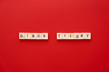 word BLACK FRIDAY made of wooden letters on red background with copy space