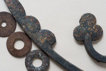 abstract composition with ironwork objects and rusty washers - photographed from above in a flat...
