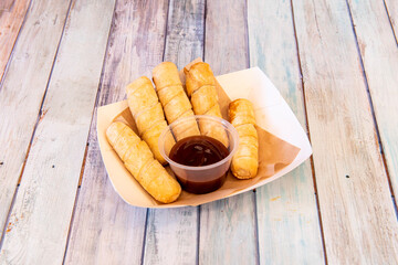 Tray of Venezuelan tequeños with sweet apple syrup