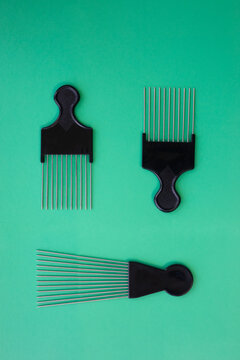 Still life shot of afro comb on a green background