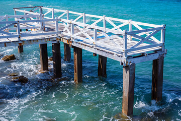Old white wooden bridge walkway over sea beach, Sang Wan beach Koh Larn, Pattaya, Thailand