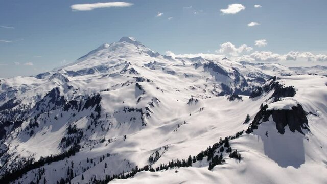 Massive Mount Baker Washington Helicopter Perspective with Blue Sky
