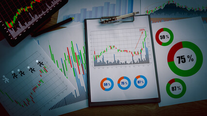 Preparing report. Green and red graphs and charts. Business reports and pile of documents on ash...