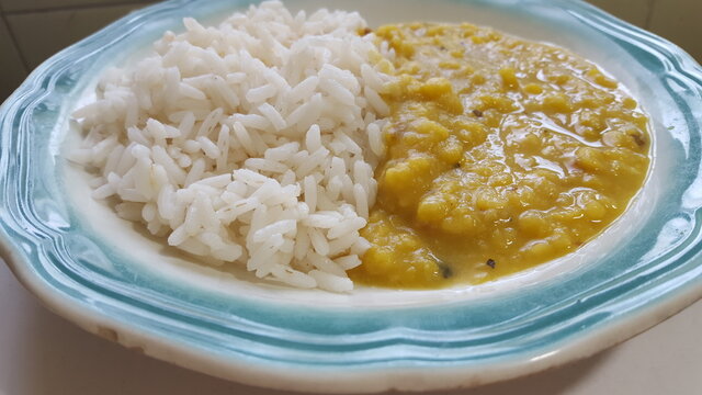 A plate of Trinidad and Tobago's traditional meal of cooked Dall or Dal, Dhal (Split peas), and Rice.  