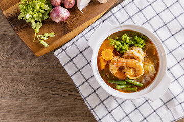 Hot and sour soup with shrimp and vegetables is a spicy Thai dish.