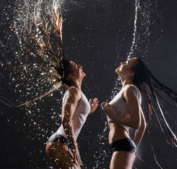 Sexy women in wet underwear having shower together
