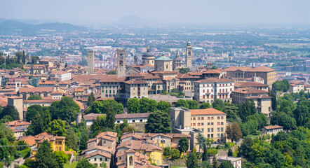 Fototapeta na wymiar Bergamo. One of the beautiful city in Italy. Landscape at the old town from San Vigilio hill. Amazing view of the towers, bell towers and main churches. Touristic destination. Best of Italy