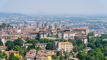 Fototapeta na wymiar Bergamo. One of the beautiful city in Italy. Landscape at the old town from San Vigilio hill. Amazing view of the towers, bell towers and main churches. Touristic destination. Best of Italy