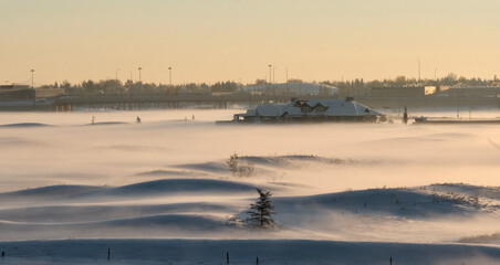 Lowrise buldings covered in fog and snow in early morning.  Kamloops.  British Columbia. Canada