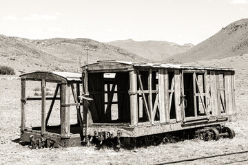 old abandoned train in the desert with mountains, in Chubut, Patagonia Argentina during summer
