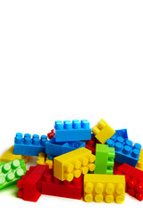 Obraz premium Multi-colored plastic designer building blocks on a white background. Colorful construction kit for kids
