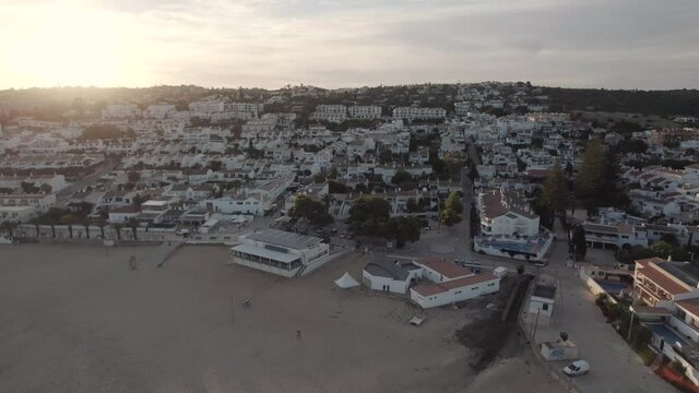 Seaside townhouses, Praia da Luz. Empty beach aerial view during sunset 