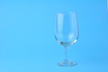 One empty glass isolated on blue background